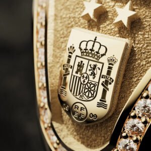 Close‑up of the Official FIFA World Cup 2026™ Champions Ring featuring Spain’s national crest engraved in gold, surrounded by pavé diamonds and two victory stars.
