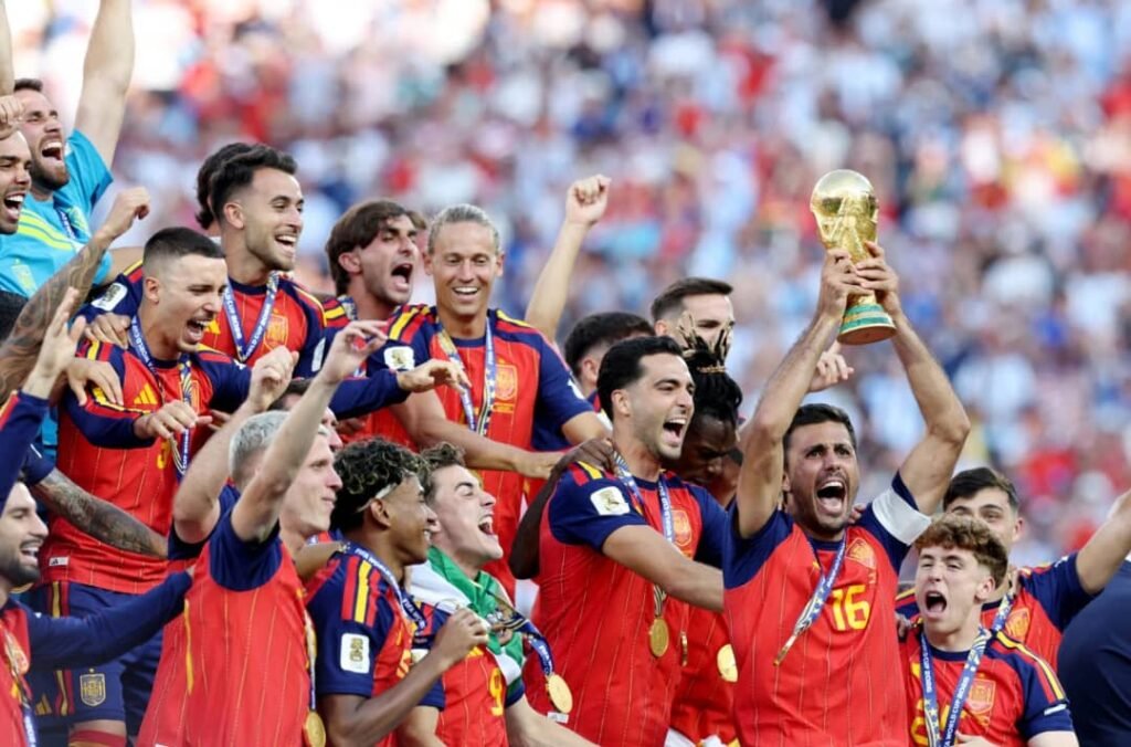 Spain national football team celebrating their FIFA World Cup 2026 victory, players lifting the trophy and wearing gold medals.